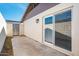 Exterior patio with neutral wall, sliding door, a privacy fence, and a metal gate at 3324 S Parkside Dr, Tempe, AZ 85282