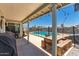 Covered back patio with grill, picnic table and view of fenced pool at 3447 E Dolphin Ave, Mesa, AZ 85204