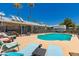 Large in-ground pool, lounge chairs, privacy fence and well-maintained yard provide the perfect backyard oasis at 3447 E Dolphin Ave, Mesa, AZ 85204