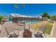 Inviting backyard featuring a pool with safety fence, firepit with chairs, and desert landscaping at 3447 E Dolphin Ave, Mesa, AZ 85204