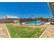 Backyard featuring a fenced pool and grassy area at 3447 E Dolphin Ave, Mesa, AZ 85204
