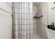 Bathroom featuring black and white shower curtain, shower with shelves, and black and white tile at 3447 E Dolphin Ave, Mesa, AZ 85204