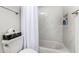 Bathroom featuring a bathtub with white marble-style tile surround and a shower curtain at 3447 E Dolphin Ave, Mesa, AZ 85204