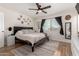 Relaxing bedroom boasts a ceiling fan, natural light and neutral colors throughout at 3447 E Dolphin Ave, Mesa, AZ 85204
