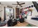 A stylish bedroom with a fan, sports decor, a window, and dark grey curtains at 3447 E Dolphin Ave, Mesa, AZ 85204