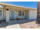 Charming house exterior showcasing a secure entry, gravel landscaping, and a well-lit porch at 3447 E Dolphin Ave, Mesa, AZ 85204