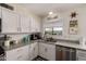 Bright kitchen features granite counters, white cabinets, stainless appliances, and modern fixtures at 3447 E Dolphin Ave, Mesa, AZ 85204