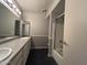 Bright bathroom with double sinks, large mirrors and a shower with glass door at 3740 E Mercer Ln, Phoenix, AZ 85028