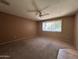Comfortable bedroom featuring a ceiling fan, neutral walls, and carpet flooring at 3740 E Mercer Ln, Phoenix, AZ 85028
