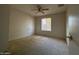 Bedroom with neutral carpet, a ceiling fan, and a window providing natural light at 3740 E Mercer Ln, Phoenix, AZ 85028