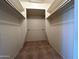 Walk-in closet featuring tiled flooring, and shelves to maximize storage space at 3740 E Mercer Ln, Phoenix, AZ 85028