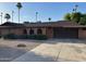 A single-story home featuring brick accents, a two-car garage, and desert landscaping at 3740 E Mercer Ln, Phoenix, AZ 85028