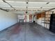 Well-lit garage featuring built-in storage shelves and a water heater at 3740 E Mercer Ln, Phoenix, AZ 85028