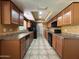 Functional kitchen featuring wood cabinetry, tile countertops, and black appliances at 3740 E Mercer Ln, Phoenix, AZ 85028