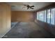 Large living room showcasing neutral walls, carpeting, and ample natural light from windows at 3740 E Mercer Ln, Phoenix, AZ 85028