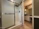 Bathroom with a sliding glass door to the shower, tiled floors and partial view of vanity at 3740 E Mercer Ln, Phoenix, AZ 85028