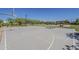 Community basketball court with a full-court layout and playground in the background at 3925 E Elmwood St, Mesa, AZ 85205
