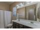 Neutral bathroom with double vanity, a large mirror, and tub shower combination at 3925 E Elmwood St, Mesa, AZ 85205