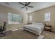 Serene bedroom with a large window providing natural light and a minimalist design for restful comfort at 3925 E Elmwood St, Mesa, AZ 85205