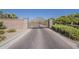 Ornate community gate with stone pillars and beautiful landscaping at 3925 E Elmwood St, Mesa, AZ 85205