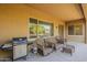 This spacious patio offers ample seating, a BBQ, and stunning views of the well-maintained backyard at 3925 E Elmwood St, Mesa, AZ 85205
