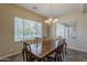 Bright dining room with large windows and a classic chandelier at 3925 E Elmwood St, Mesa, AZ 85205