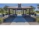 The interior of a community gazebo with stone accents, picnic tables, and a central fireplace at 3925 E Elmwood St, Mesa, AZ 85205