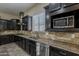 Gourmet kitchen featuring granite countertops, stainless steel appliances, and custom cabinetry at 3925 E Elmwood St, Mesa, AZ 85205