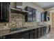 Well-equipped kitchen with stainless steel range hood, granite countertops, and gas cooktop at 3925 E Elmwood St, Mesa, AZ 85205