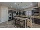 Spacious kitchen featuring dark cabinets, granite countertops, and stainless steel appliances at 3925 E Elmwood St, Mesa, AZ 85205