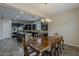 Open-concept kitchen and dining area with elegant chandelier and dark cabinetry at 3925 E Elmwood St, Mesa, AZ 85205