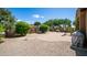 Serene backyard featuring gravel landscaping, a circular brick patio, and a lush garden area at 3994 E Grand Canyon Pl, Chandler, AZ 85249