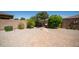 Private backyard with gravel landscaping, mature trees, a brick patio, and a cozy swing bench at 3994 E Grand Canyon Pl, Chandler, AZ 85249