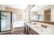 Spacious bathroom featuring a double vanity, soaking tub, walk-in shower, and tiled floors at 3994 E Grand Canyon Pl, Chandler, AZ 85249