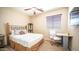 Cozy bedroom with a bed, side table, workspace, and window with blinds at 3994 E Grand Canyon Pl, Chandler, AZ 85249