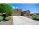 Inviting home exterior with a long driveway, lush landscaping, and a well-maintained lawn at 3994 E Grand Canyon Pl, Chandler, AZ 85249