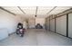 Spacious garage with an epoxy floor, ample storage cabinets, and room for parking and projects at 3994 E Grand Canyon Pl, Chandler, AZ 85249