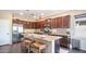 Modern kitchen featuring stainless steel appliances, a center island with bar seating, and dark wood cabinetry at 3994 E Grand Canyon Pl, Chandler, AZ 85249