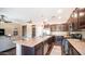 Well-lit kitchen with a center island, dark wood cabinets, stainless steel appliances, and open layout at 3994 E Grand Canyon Pl, Chandler, AZ 85249