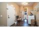 Well-lit laundry room featuring a front-load washer, tile floors, and convenient access to the outdoors at 3994 E Grand Canyon Pl, Chandler, AZ 85249