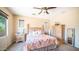 Bright main bedroom with queen bed, ceiling fan, and dresser with mirror at 3994 E Grand Canyon Pl, Chandler, AZ 85249