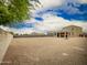 Large backyard with gravel and perimeter block wall, and covered patio at 4061 N 308Th Ln, Buckeye, AZ 85396