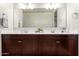 Bright bathroom featuring double sinks, undermount sinks, and large mirror at 4061 N 308Th Ln, Buckeye, AZ 85396