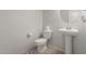 Neutral powder room featuring a pedestal sink, toilet, and decorative mirror at 4061 N 308Th Ln, Buckeye, AZ 85396