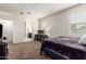 Bedroom with neutral carpet, two windows, and en suite bathroom access at 4061 N 308Th Ln, Buckeye, AZ 85396