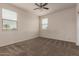 Inviting bedroom featuring carpet floor, ceiling fan, and natural light at 4061 N 308Th Ln, Buckeye, AZ 85396