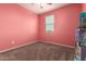 Clean bedroom with carpet flooring, window, and a dollhouse at 4061 N 308Th Ln, Buckeye, AZ 85396