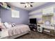 Comfortable bedroom with ceiling fan and horizontal purple and white stripes at 4061 N 308Th Ln, Buckeye, AZ 85396