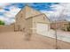 Side angle of a two-story home with a two-car garage, and a private backyard at 4061 N 308Th Ln, Buckeye, AZ 85396