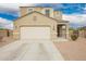 Charming beige home with a two-car garage, concrete driveway, and landscaped front yard at 4061 N 308Th Ln, Buckeye, AZ 85396